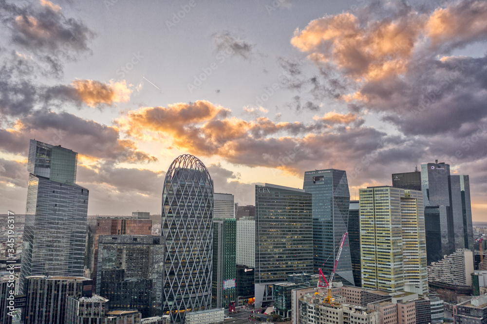 Fototapeta premium Dec 24, 2019 - Paris, France: Aerial view of la defense skyscraper complex during sunset with clouds