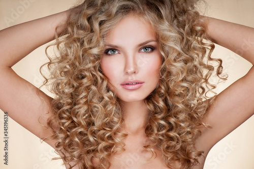 Beautiful blonde woman. Healthy Long Blond Hair. Curly Hair. Blond. Permed Hair. Afro curls. Long blond Hair.  Beauty Model Girl with Luxurious Hair.