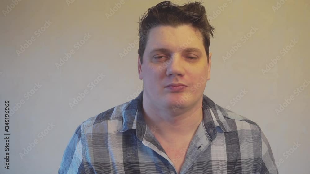 Portrait of a funny emotional man who throws up an orange Portrait of a funny emotional man who throws up an orange