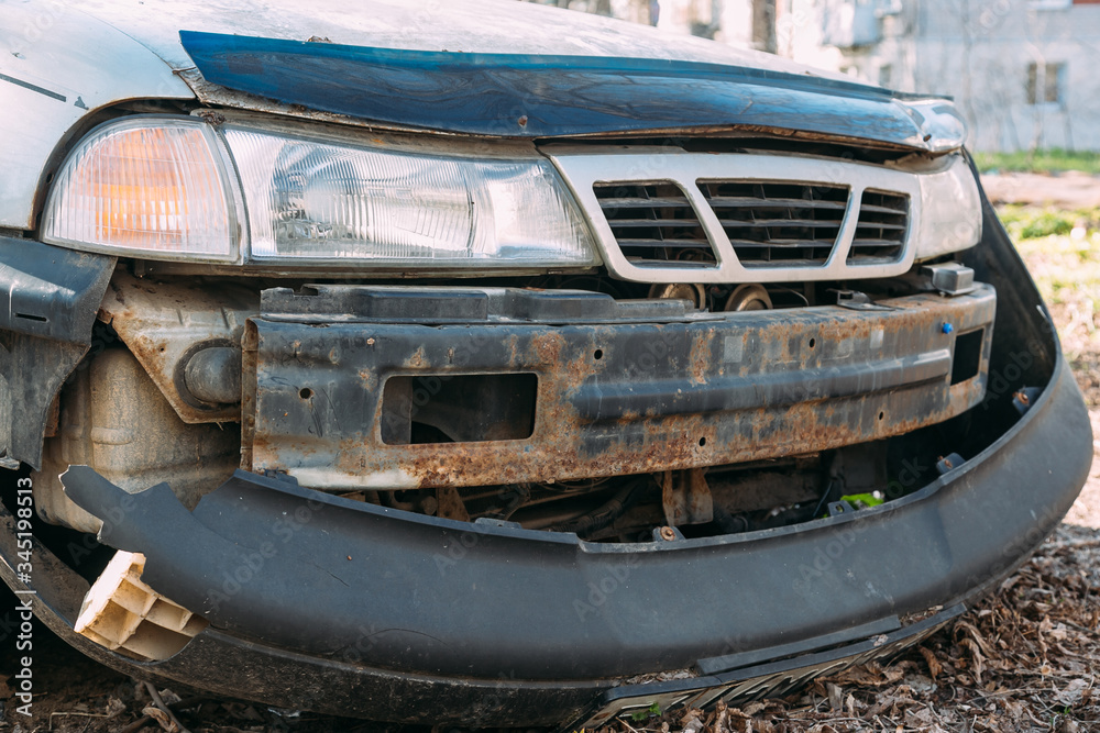 Fototapeta premium Abandoned old car wreck in the outdoors
