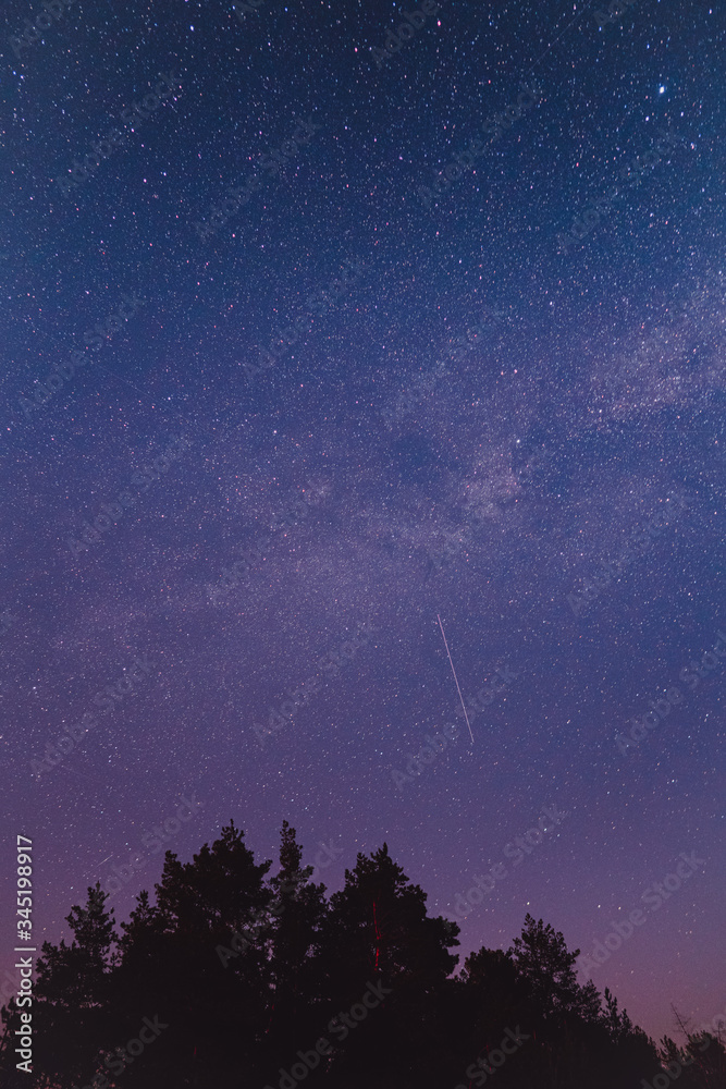 Naklejka premium Landscape with blue Milky Way. Night sky with stars. Beautiful milky way taken in Ukraine during a clear night