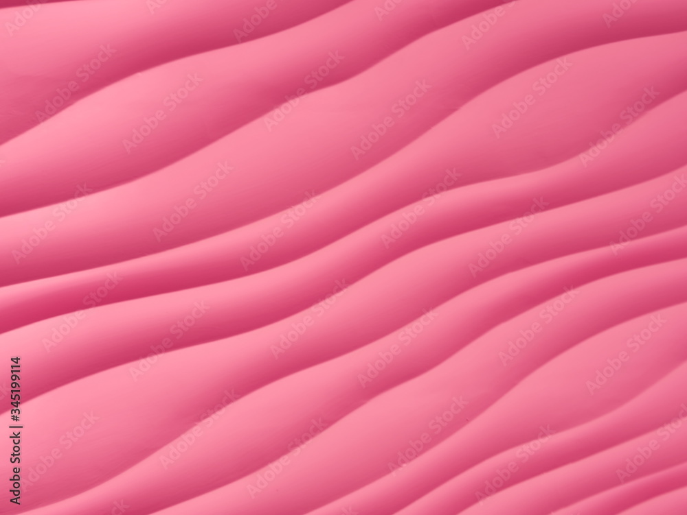 Fototapeta premium pink waved pattern close up. abstract textured pink painted back