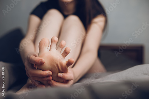 Фотография Close up woman foot massage to relieve pain from ache
