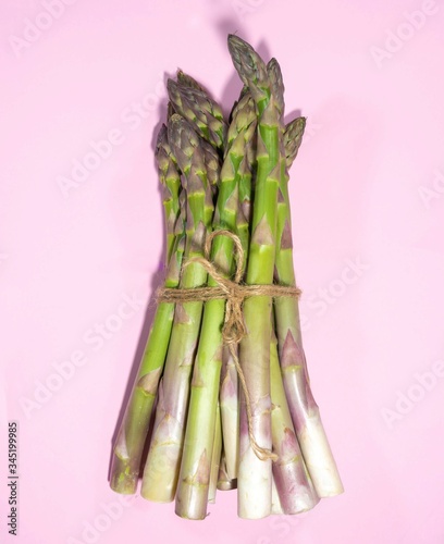 Asparagus on a pink background.