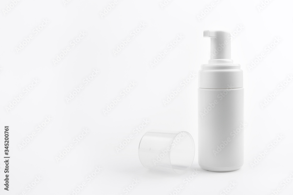 Photo of white plastic cosmetic bottle for foam over white background. Health and body care concept. Photo of white plastic cosmetic bottle for foam over white background. Health and body care concept.