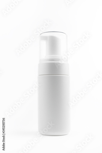 Photo of white plastic cosmetic bottle for foam over white background. Health and body care concept.
