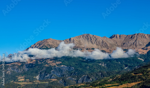 Beautiful landscape with clouds and peaks in  The Southern French Alps in Alpes-de-Haute-Provence region.
