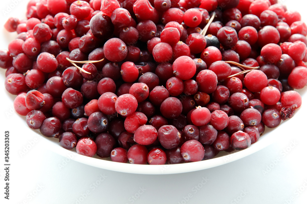Frozen red cranberries in the white plate