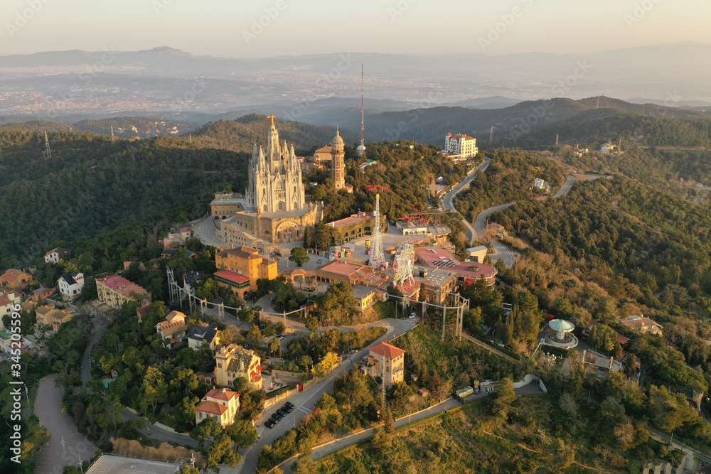 Aerial view of Tibidabo mountain with amusement park overlooking city of Barcelona, Spain.