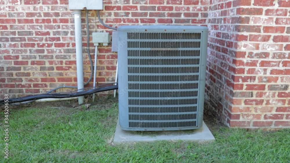 Shot of air conditioner unit as camera moves slowly moves to the left