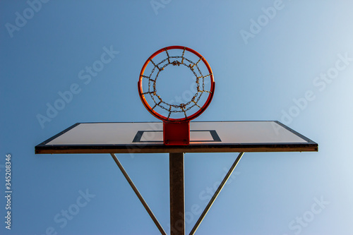 Basketball ring with a blue sky background. Down view.
