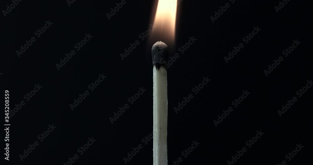 Match lighting and burning till the end and finally disappears from the flame on black background