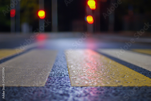 crosswalk at night street  blurred   traffic lights  defocused city background