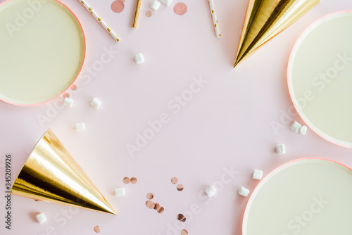 frame of birthday party supplies. dusty pink background