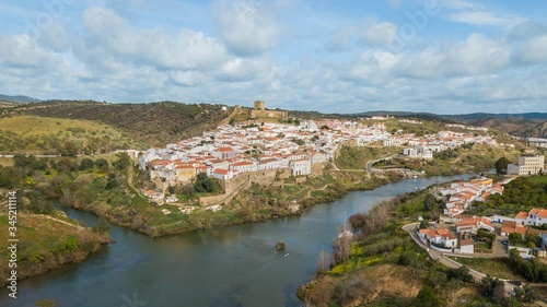 Aerial view of the city of Mértola. Historic center of Mértola, castle, church, and Guadiana river, Alentejo, Portugal