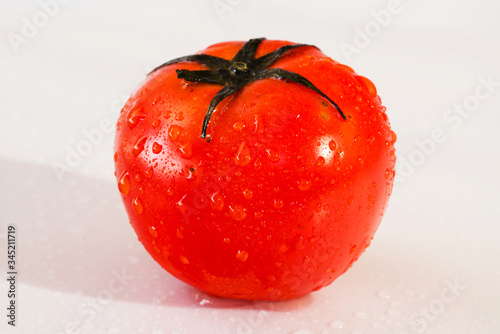 Fresh organic tomatoes with dew drops isolated on white background