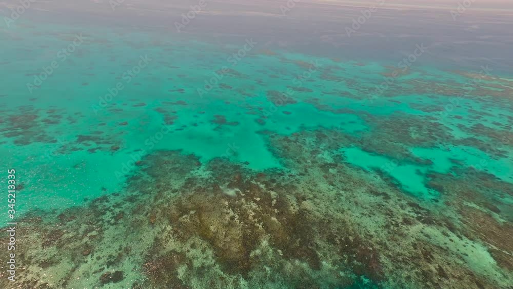 Great Barrier Reef Blue Sea view. Beautiful aqua & turquoise waters, with coral reef patterns in the ocean. View from helicopter, on vacation. Marine life, global warming, protection, island. 4K. Great Barrier Reef Blue Sea view. Beautiful aqua & turquoise waters, with coral reef patterns in the ocean. View from helicopter, on vacation. Marine life, global warming, protection, island. 4K.