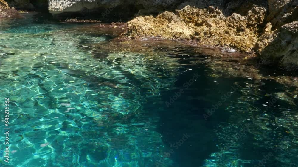 Watching crystal clear turquoise sea waters and the rocky cliff. camera moves from sea Watching crystal clear turquoise sea waters and the rocky cliff. camera moves from sea