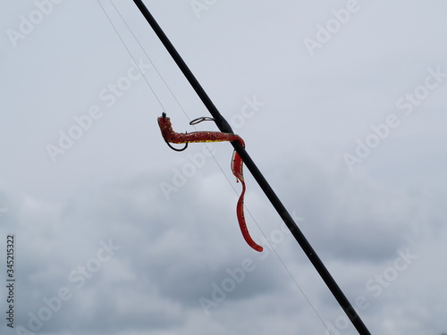 fishing hook on blue sky background
