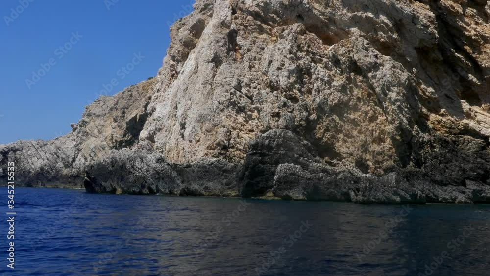 Tracking shot pov watching crystal clear turquoise sea waters and the rocky cliff island camera moves in the sea Tracking shot pov watching crystal clear turquoise sea waters and the rocky cliff island camera moves in the sea