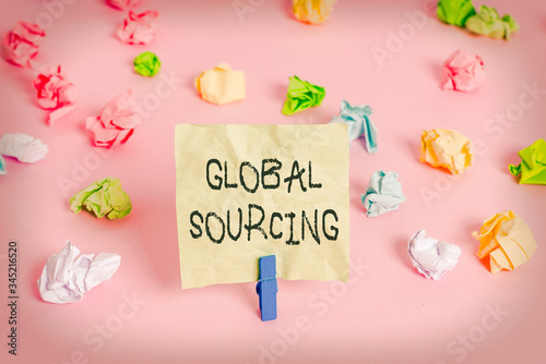 Conceptual hand writing showing Global Sourcing. Concept meaning practice of sourcing from the global market for goods Colored crumpled papers empty reminder pink floor clothespin photo