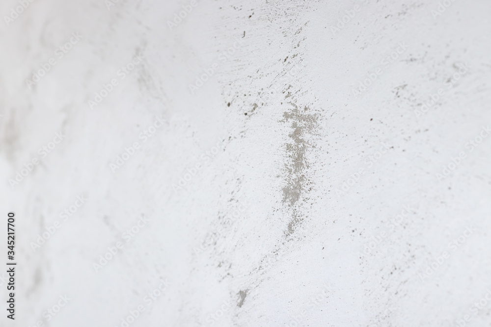 Defocused gray concrete wall painted in white and gray, loft style.