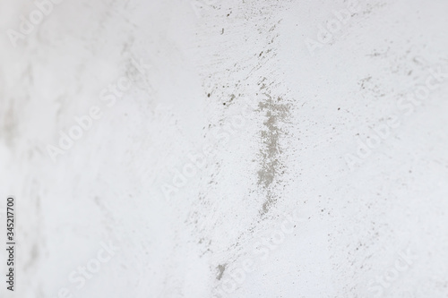 Defocused gray concrete wall painted in white and gray, loft style.