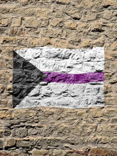 Rocky wall with the demisexual flag painted on it. photo