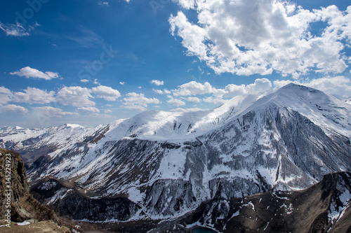 Beautiful panorama of the Caucasus mountains with clouds above them