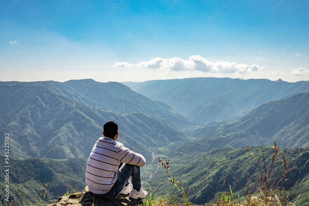 man watching the beautiful mountain range from edge of mountain