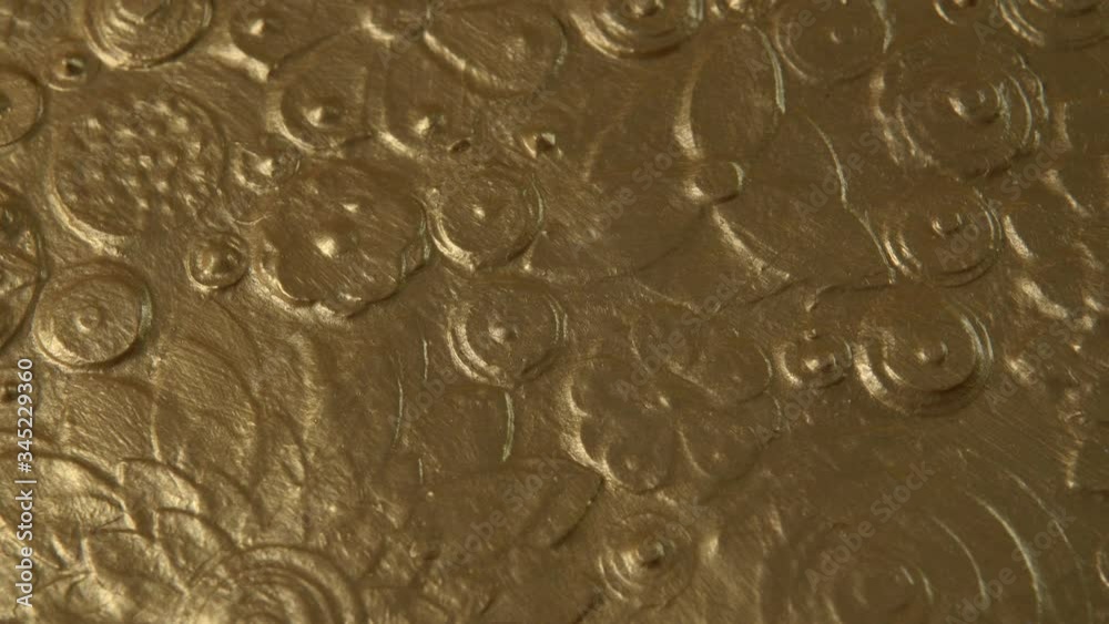Abstract gold flower art close up. Golden floral background, texture painting covered with metallic dust. Shining slow motion drapery loop. Luxurious Diwali yellow grungy paint surface rotation. 4k. Abstract gold flower art close up. Golden floral background, texture painting covered with metallic dust. Shining slow motion drapery loop. Luxurious Diwali yellow grungy paint surface rotation. 4k.