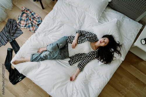 Tableau sur toile above view of asian female lying in bed feeling depressed, lack of motivation to do anything