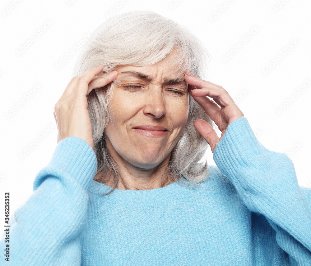 health and people concept: senior lady having headache over white background health and people concept: senior lady having headache over white background
