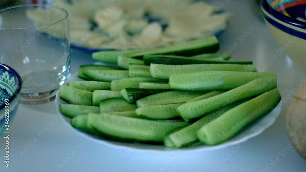 Fresh chopped cucumbers. Fresh cucumbers on a white plate. Fresh chopped cucumbers. Fresh cucumbers on a white plate.