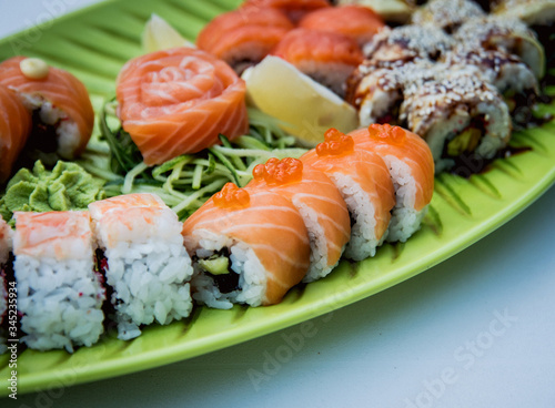 Large sushi set on the green plate.