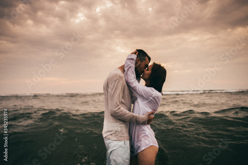  Happy lovers have a cheerful vibes on sea beach at sunset   © Nikita