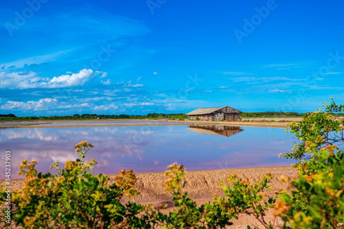 Salt barn with blue sky background in salt fields at Bang Tabun city of Petchaburi province, Thailand photo