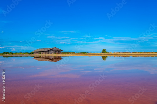 Salt barn with blue sky background in salt fields at Bang Tabun city of Petchaburi province, Thailand photo