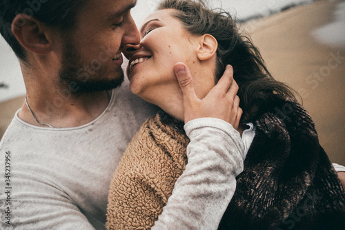 Happy lovers have a cheerful vibes on sea beach at sunset 