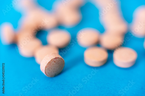 Selective focus shot showing tablets, on blue showing the antiviral cure for coronavirus covid19 pandemic ravaging the world photo