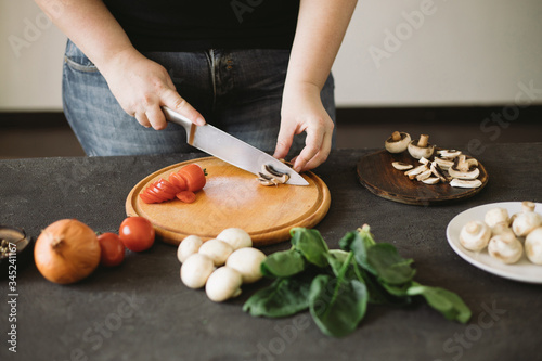 Diet concept, healthy lifestyle, low calorie food. Closeup portrait of woman cooking healthy dinner of vegetables and mushrooms