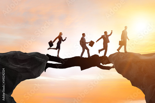 Photos Businessman acting as a bridge in support concept