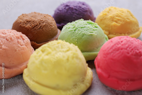 Various flavored ice cream scoops  close up. Food background  refreshment  rainbow  variety  cool seasonal sweets  refreshment concept