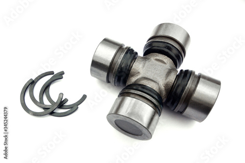 Cross of a cardan shaft of a car with circlips on a white background.  Spare parts.