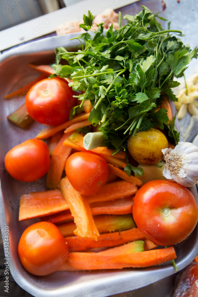 Tajine ingredients vegetables: tomatoes, carrots, pepper garlic, parsley
