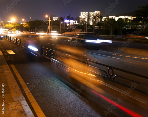 Cars on the road in the city in motion at night. © schankz