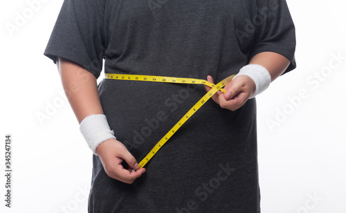 Fat man holding a measurement tape for check out his body isolated on white background.