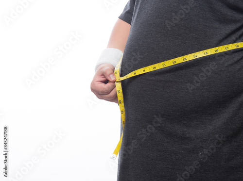 Fat man holding a measurement tape for check out his body isolated on white background.