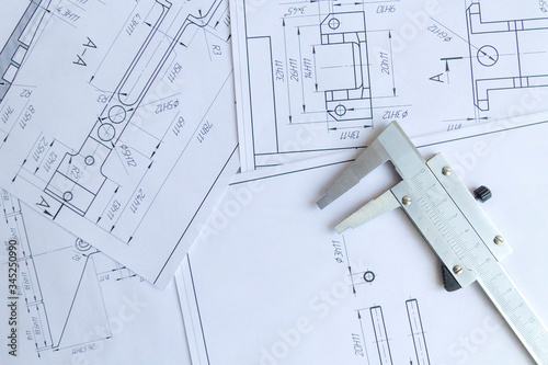 Top view of a caliper measuring tool, ruler and detail drawings.Engineering drawings, metal detail. photo