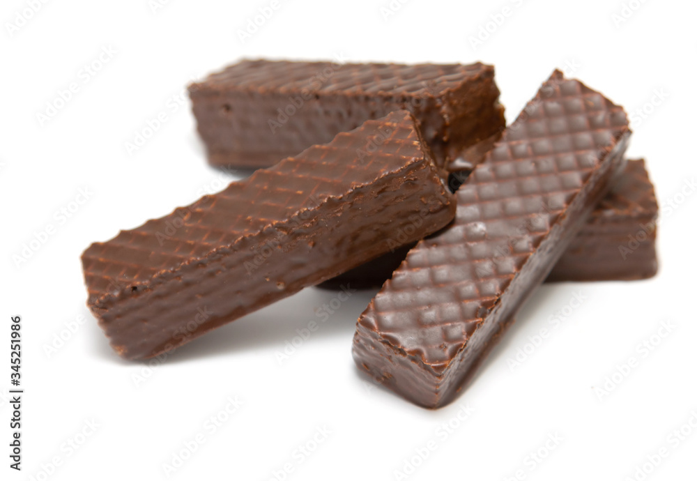 Chocolate waffle cookies with sweets on a white background. Chocolate waffle cookies with sweets on a white background.